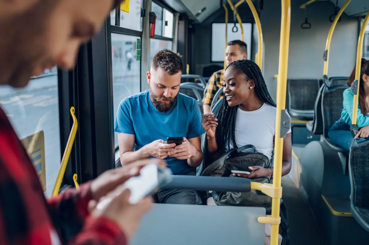 People on a bus booking an appointment online