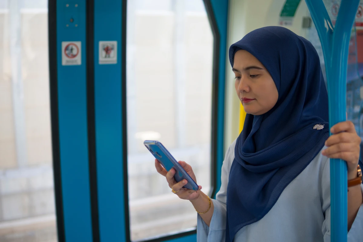 Image of a woman on phone while on public trasport